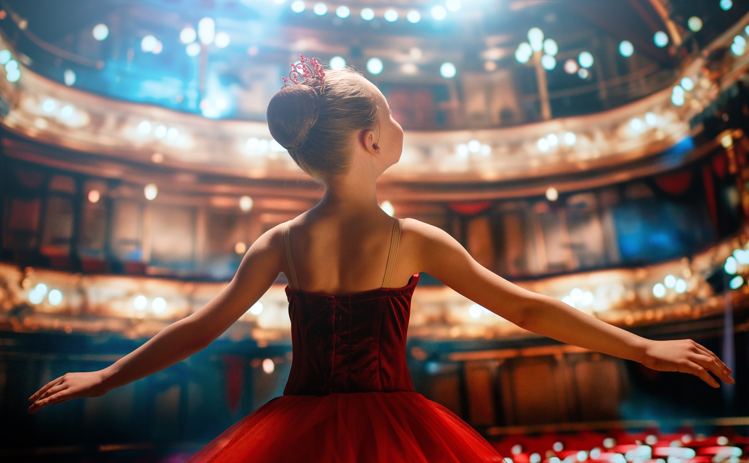A ballet studio with dancers training at the barre.